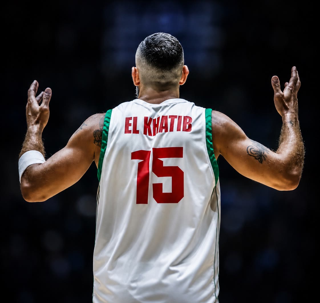 Fadi Al Khatib in the number 15 jersey, arms raised to the crowd